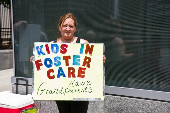 Virginia McKale protests outside Family Court Friday. She’s been separated from her grandchildren since October. (Kimberly Paynter/WHYY)
