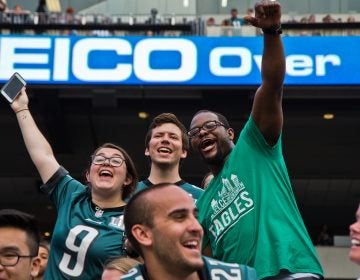 Excited Eagles fans cheer for the team at their first open practice of the season at Lincoln Financial Field Sunday evening. (Kimberly Paynter/WHYY)