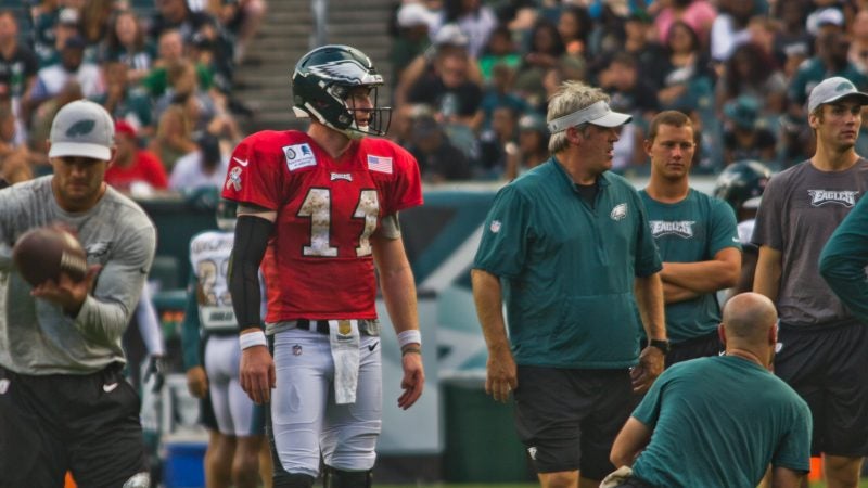 Eagles head coach Dough Pederson (right) and starting quarterback Carson Wentz on the field at the team's open practice Sunday evening. (Kimberly Paynter/WHYY)