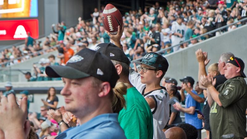 Excited Eagles fans cheer for the team at their first open practice of the season at Lincoln Financial Field Sunday evening. (Kimberly Paynter/WHYY)