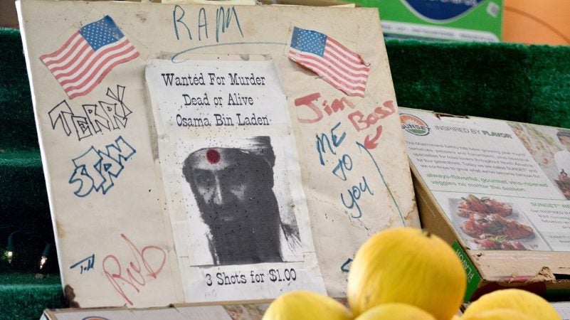 A homemade dartboard with a picture of Osama Bin Laden is found amid the produce at Zern's Farmers Market in Gilbertsville, Pa., on Aug. 24, 2018. (Bastiaan Slabbers for WHYY)