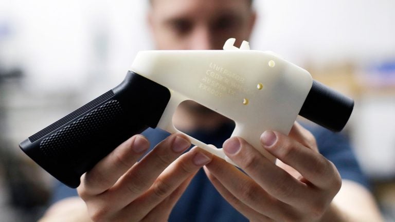 In this Aug. 1, 2018, file photo, Cody Wilson, with Defense Distributed, holds a 3D-printed gun called the Liberator at his shop in Austin, Texas. A federal judge in Seattle has granted an injunction that prohibits the Trump administration from allowing a Texas company to post 3D gun-making plans online. (AP Photo/Eric Gay, file)