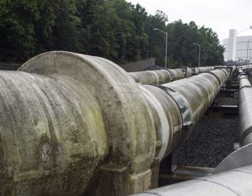 Transfer pipes carry liquified natural gas to and from a holding tank, seen in background, at Dominion Energy's Cove Point LNG Terminal in Lusby, Md., Thursday, June 12, 2014. Federal regulators concluded that Dominion Energy's proposal to export liquefied natural gas from its Cove Point terminal on the Chesapeake Bay in Maryland would pose 