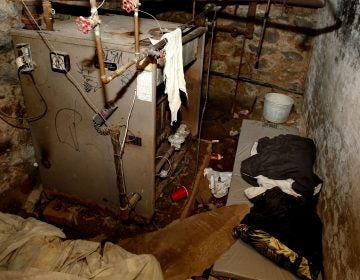 The dank basement room in Philadelphia where four weak and malnourished mentally disabled adults, one chained to the boiler, were found locked inside on Saturday is shown Monday, Oct. 17, 2011. Police arrested three adults staying in an apartment upstairs, including the person accused of being the ringleader, Linda Ann Weston, in what authorities say is a scheme to steal the Social Security disability checks of defenseless and vulnerable people. (Ron Cortes/AP Photo, Pool)