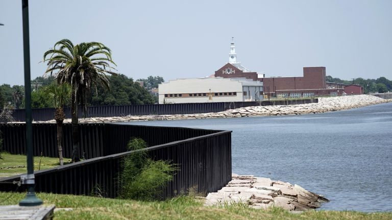 A seawall, which will be increased in size, is shown along the banks near downtown Thursday, July 26, 2018, in Port Arthur, Texas.  The oil industry wants the government to help protect some of its facilities on the Texas Gulf Coast against the effects of global warming. One proposal involves building a nearly 60-mile “spine” of flood barriers to shield refineries and chemical plants. Many Republicans argue that such projects should be a national priority. But others question whether taxpayers should have to protect refineries in a state where top politicians still dispute whether climate change is real. (David J. Phillip/AP Photo)