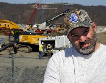 In this April 30, 2018 photo, Chip Kohser, the Beaver county Republican chairman, stands overlooking the construction of a chemical plant on the banks of the Ohio River near Beaver, Pa., that will help convert natural gas into plastic, creating hundreds of jobs in an area that has seen population dwindle since the collapse in the 1980's of the steel industry. (AP Photo/Gene J. Puskar)