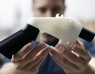 In this Aug. 1, 2018, file photo, Cody Wilson, with Defense Distributed, holds a 3D-printed gun called the Liberator at his shop in Austin, Texas. A federal judge in Seattle heard arguments Tuesday, Aug. 21, 2018, on whether to block a settlement the U.S. State Department reached with a company that wants to post blueprints for printing 3D weapons on the internet. (Eric Gay/AP Photo)