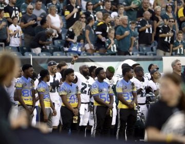 Philadelphia Eagles' Malcolm Jenkins, center left, raises his fist during the national anthem before the team's preseason NFL football game against the Pittsburgh Steelers, Thursday in Philadelphia. (AP Photo/Matt Rourke)
