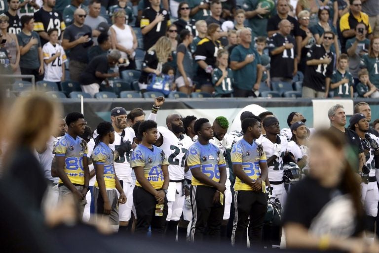 Philadelphia Eagles' Malcolm Jenkins, center left, raises his fist during the national anthem before the team's preseason NFL football game against the Pittsburgh Steelers, Thursday in Philadelphia. (AP Photo/Matt Rourke)