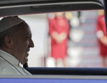 Pope Francis sits in a car