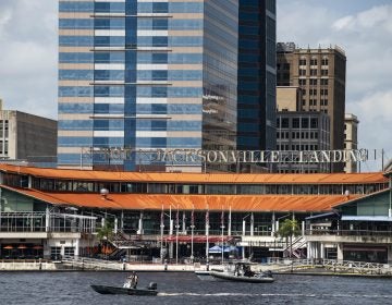 The Coast Guard patrols the St. Johns River outside The Jacksonville Landing in Jacksonville, Fla., Sunday, Aug. 26, 2018. Florida authorities are reporting multiple fatalities after a mass shooting at the riverfront mall that was hosting a video game tournament. (AP Photo/Laura Heald)