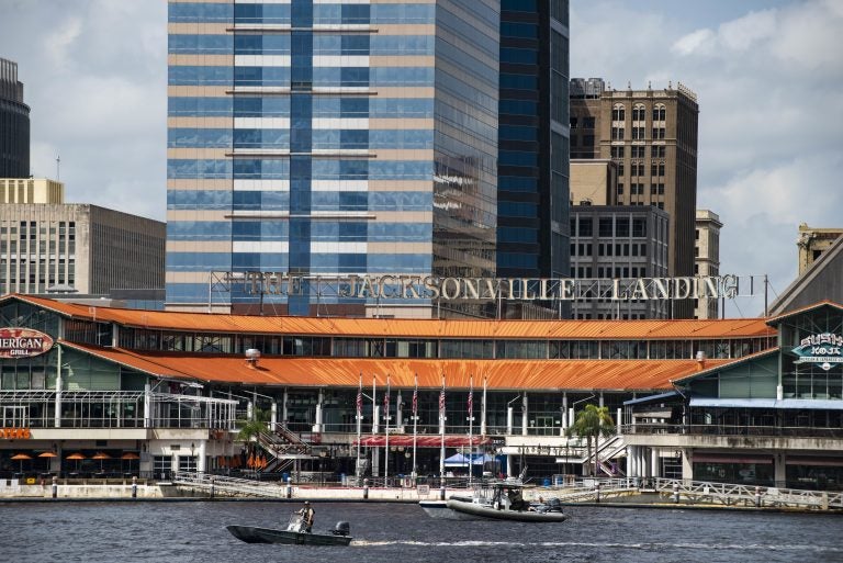 The Coast Guard patrols the St. Johns River outside The Jacksonville Landing in Jacksonville, Fla., Sunday, Aug. 26, 2018. Florida authorities are reporting multiple fatalities after a mass shooting at the riverfront mall that was hosting a video game tournament. (AP Photo/Laura Heald)