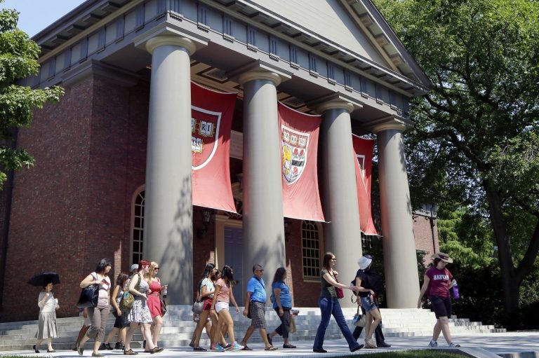 In this Aug. 30, 2012, file photo, a tour group walks through the campus of Harvard University in Cambridge, Mass. The Justice Department has sided with Asian-American students suing Harvard University over the Ivy League school's consideration of race in its admissions policy. (Elise Amendola/AP Photo, File)