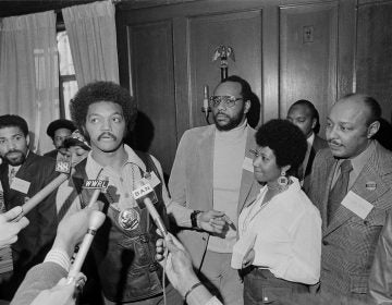 Rev. Jesse Jackson speaks to reporters at the Operation PUSH Soul Picnic at the 142nd Street Armory in New York, March 26, 1972. Left to right are: Betty Shabazz, behind Jackson, widow of Malcolm X; Jackson; Tom Todd, vice president of PUSH; Aretha Franklin and Louis Stokes. PUSH stands for People United to Save Humanity. (AP Photo/Jim Wells)