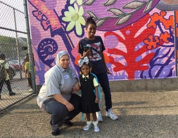 Quimayah Gibson-McClendon prepares for her first day of kindergarten at William Dick School in North Philadelphia with her great-aunt Elesha Sears (left), and grandmother Tashawn McClendon, (Avi Wolfman-Arent/WHYY) 