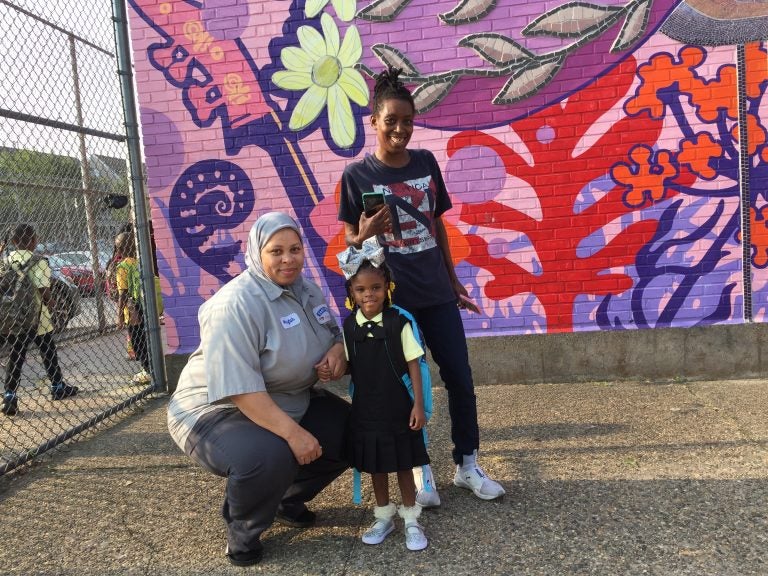 Quimayah Gibson-McClendon prepares for her first day of kindergarten at William Dick School in North Philadelphia with her great-aunt Elesha Sears (left), and grandmother Tashawn McClendon, (Avi Wolfman-Arent/WHYY) 