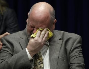 Former priest James Faluszczak, who says he was molested by a priest as a teenager, reacts as Pennsylvania Attorney General Josh Shapiro speaks during a news conference at the Pennsylvania Capitol in Harrisburg, Pa., Tuesday, Aug. 14, 2018. (AP Photo/Matt Rourke)