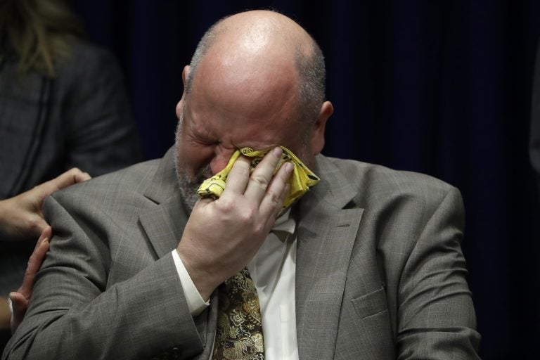 Former priest James Faluszczak, who says he was molested by a priest as a teenager, reacts as Pennsylvania Attorney General Josh Shapiro speaks during a news conference at the Pennsylvania Capitol in Harrisburg, Pa., Tuesday, Aug. 14, 2018. (AP Photo/Matt Rourke)