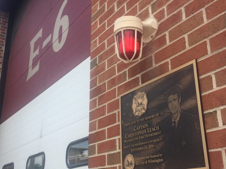 A plaque dedicated to Christopher Leach, one of three Wilmington firefighters killed in a September 2016 fire, is affixed to Station 6.. The term E6 refers to Engine 6, water-carrying truck that normally operates out of the station, but was mothballed the night the trio died 
while battling the blaze. (Cris Barrish/WHYY)