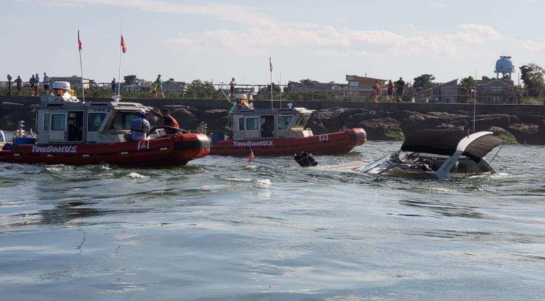 Commercial salvage crews arrive at the scene of a partially sunken boat in the Barnegat Inlet Thursday. (USCG image)