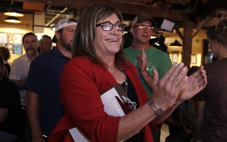 Vermont Democratic gubernatorial nominee Christine Hallquist, a transgender woman and former electric company executive, applauds with her supporters during her election night party in Burlington, Vt.