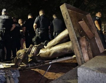 Police stand guard after the Confederate statue known as 