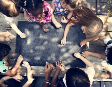 Kids drawing on a chalkboard. (Photo Courtesy/Bigstock)