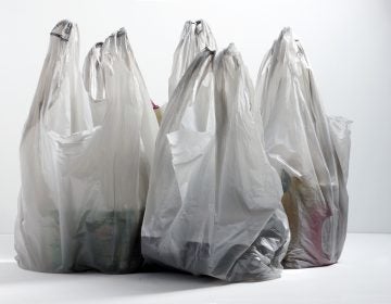 Multiple plastic shopping bags on table top (Big Stock)