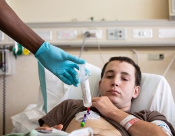 Patient Aaron Reid receives (CAR) T-cell therapy at the NIH in Bethesda, MD. The process took five minutes to complete. (Pearl Mak/NPR)