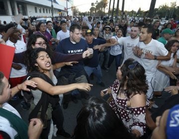 Protesters surround a Trump supporter on S. Almaden Boulevard outside the San Jose Convention Center as Presidential candidate Donald Trump holds a rally in San Jose, Calif., Thursday, June 2, 2016. (Patrick Tehan/Bay Area News Group Archives)