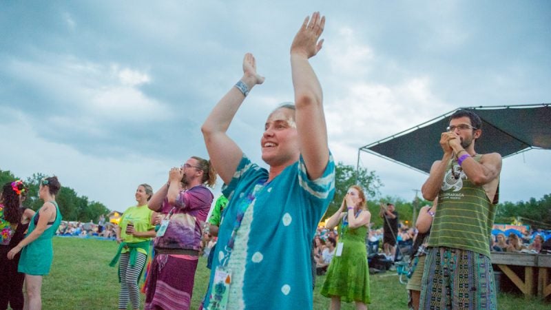 Julia Hoff applauds the group BeauSoleil during the Saturday evening performance. (Jonathan Wilson for WHYY)