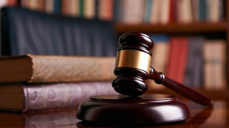 Judge's gavel on wooden table with law books. (bigstockphoto.com)