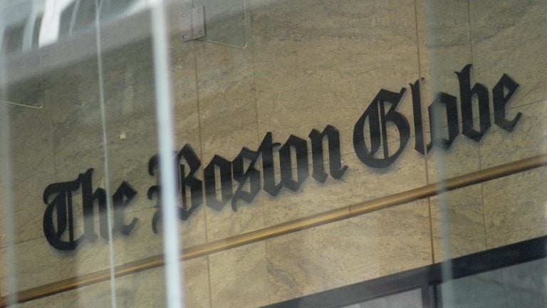 The Boston Globe's logo as seen through the windows across from the new location of the Globe in Boston. The paper's editors coordinated a campaign defending a free press in editorials.