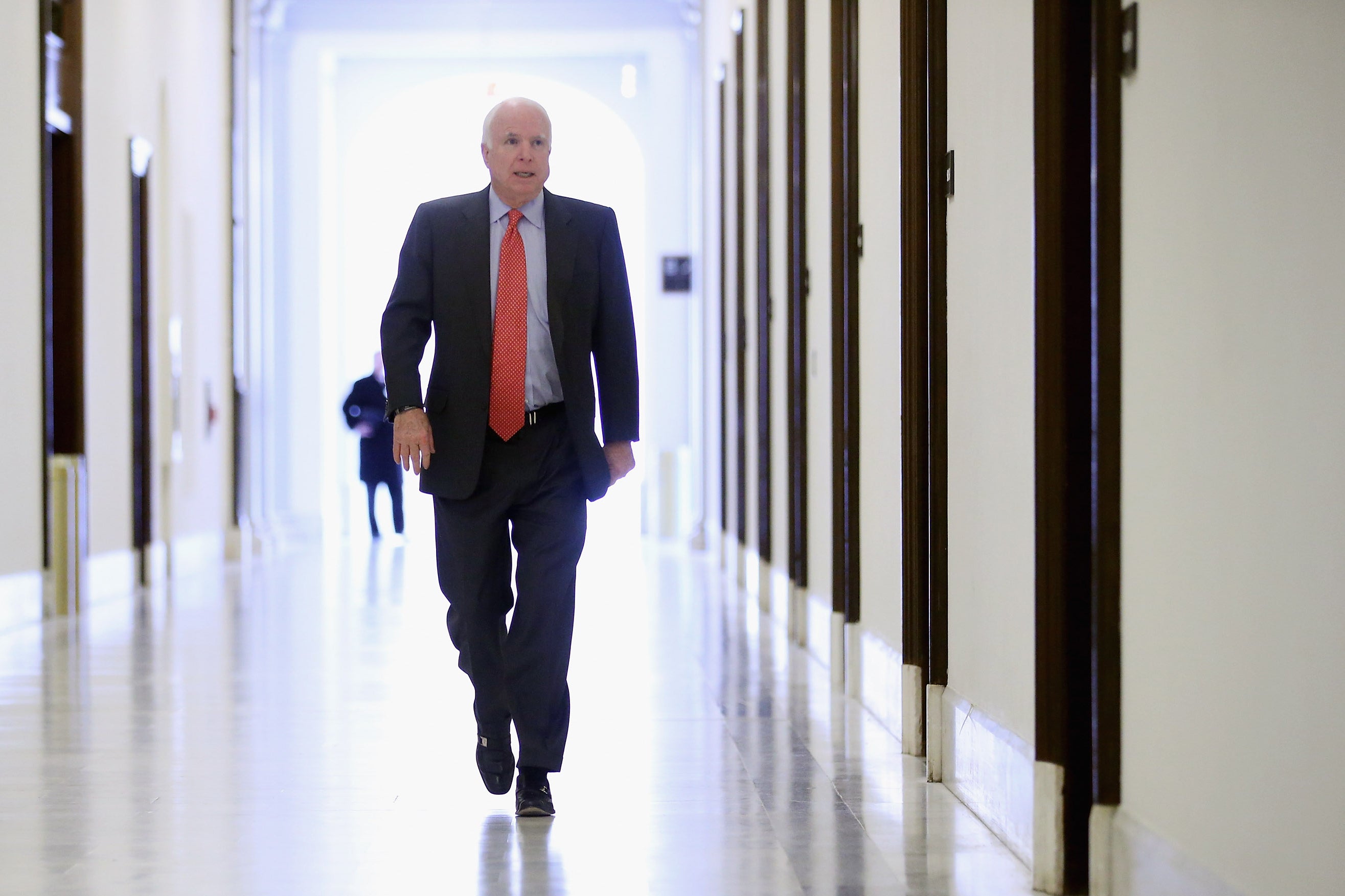 McCain heads to his office in the Russell Senate Office Building in 2013.