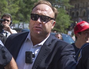 Alex Jones and his Infowars channels have been removed from YouTube; Facebook and Apple's iTunes have also deleted most or all of his outlets on their services. He's seen here being escorted from a rally near the 2016 Republican National Convention.
Tom Williams/CQ-Roll Call Inc.