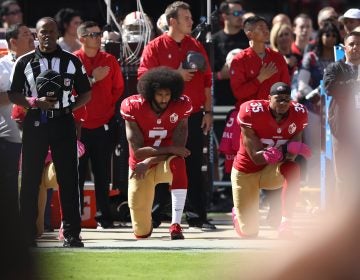 Colin Kaepernick, seen kneeling beside teammate Eric Reid during the national anthem before a game in 2016, catalyzed a series of protests against police brutality that continue to roil the NFL. (Ezra Shaw/Getty Images)