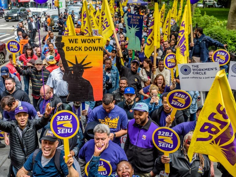 Cashiers, cooks, delivery people, fast-food workers and their supporters rallied outside New York City Hall in 2017. Their influential union, the Service Employees International Union, also includes about half a million home health aides. (Pacific Press/LightRocket/Getty Images)