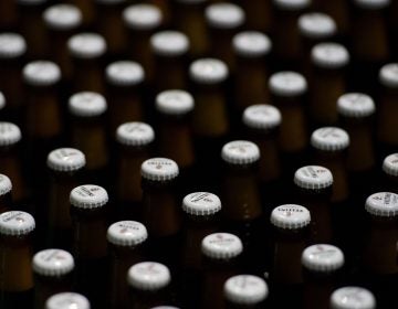 Beer bottles with crowned caps crowd the conveyor belts of a filling plant in the Veltins brewery in Meschede-Grevenstein, western Germany, in January.
(Rainer Jensen/AFP/Getty Images)