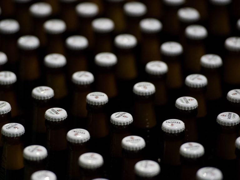 Beer bottles with crowned caps crowd the conveyor belts of a filling plant in the Veltins brewery in Meschede-Grevenstein, western Germany, in January.
(Rainer Jensen/AFP/Getty Images)