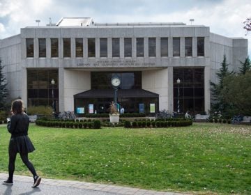 A student walks past the Bender Library on the American University campus in Washington, D.C. American is one of 32 colleges and universities with an accelerated program that lets students earn bachelor’s degrees in thee years instead of four, which one management expert has criticized for helping only undergraduates who are already very well prepared. (Nikki Kahn/The Washington Post via Getty Images)