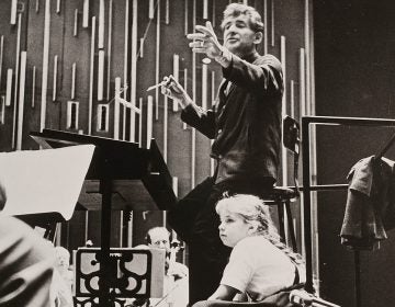 Jamie Bernstein watches her father, Leonard Bernstein, conduct the New York Philharmonic at a rehearsal for one of his Young People's Concerts, circa fall 1962. (Bob Serating /New York Philharmonic Leon Levy Digital Archives)