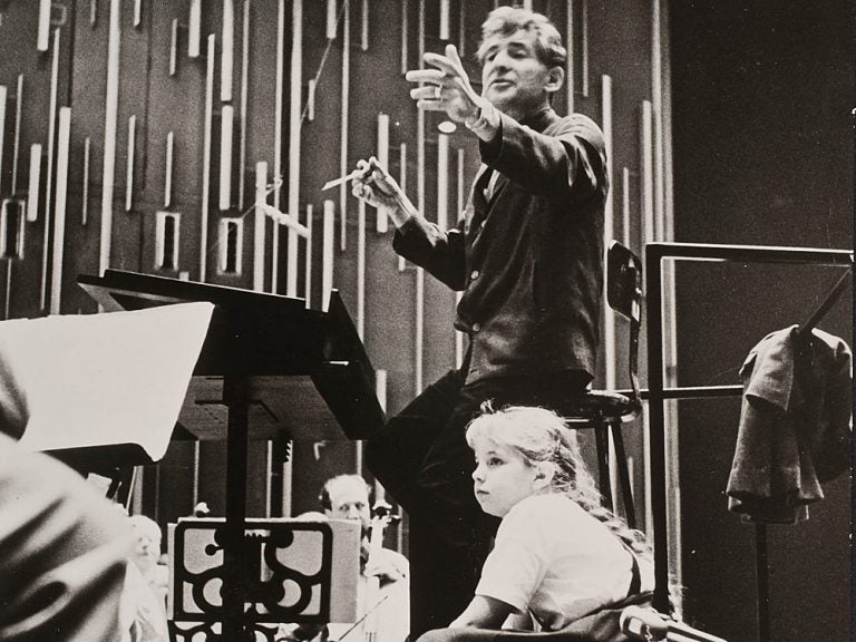 Jamie Bernstein watches her father, Leonard Bernstein, conduct the New York Philharmonic at a rehearsal for one of his Young People's Concerts, circa fall 1962. (Bob Serating /New York Philharmonic Leon Levy Digital Archives)