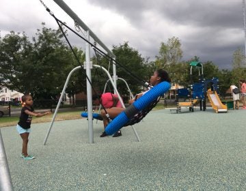 Youngsters try out the new swings at Lanier Playground during a tour in advance of its official reopening. 
 Malcolm Burnley/PlanPhilly)