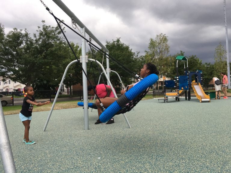 Youngsters try out the new swings at Lanier Playground during a tour in advance of its official reopening. 
 Malcolm Burnley/PlanPhilly)