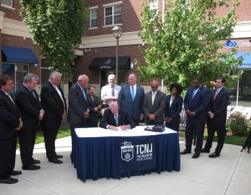 Governor Phil Murphy signs the new law at the College of New Jersey (Phil Gregory/WHYY News)