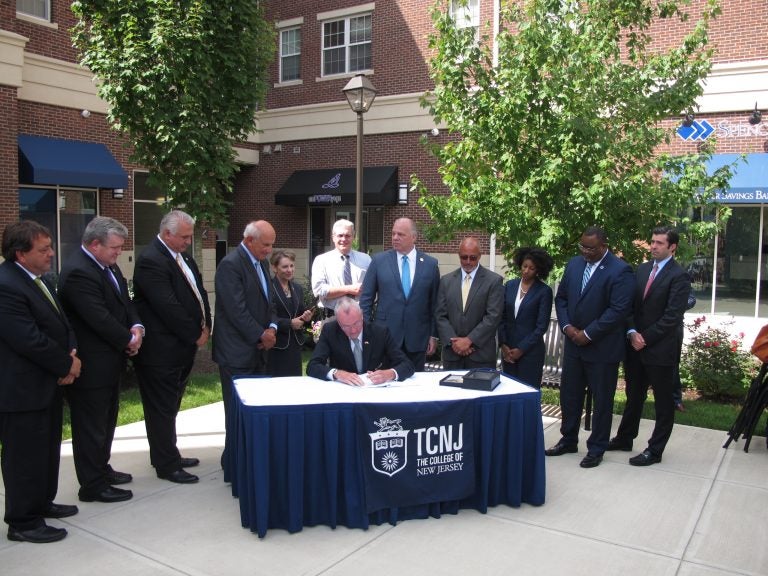 Governor Phil Murphy signs the new law at the College of New Jersey (Phil Gregory/WHYY News)