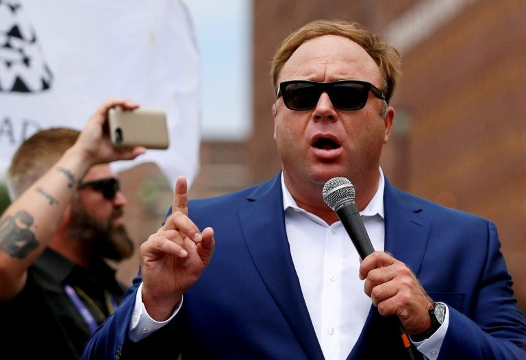 Alex Jones, shown here at a July 2016 rally in support of then-candidate Donald Trump, says he is being subjected to a 