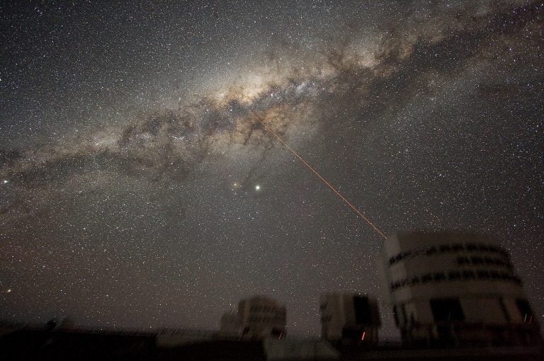 The Milky Way's Galactic Center in the night sky above the Paranal Observatory (the laser creates a guide-star for the telescope). ESO/Y. Beletsky