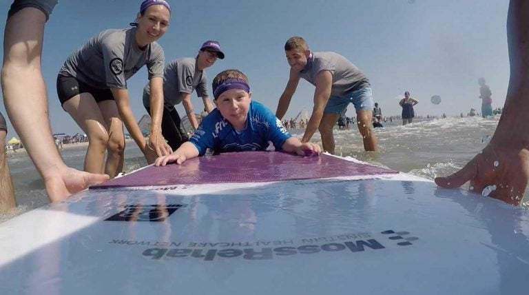 One of the 100+ surfers — and some of the volunteers — who participated in MossRehab's They Will Surf Again event in Wildwood, New Jersey. Photo Credit: Alex Felts and Chelsea Bronstein