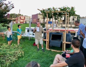 Tony Guido explains features of a composting vessel he helped build for a Philadelphia Food Policy Advisory Council design competition. (Meir Rinde/PlanPhilly)